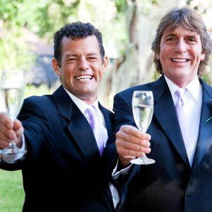 Gay couple toasting with champagne.